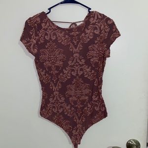 Chic blush bodysuit with floral detail